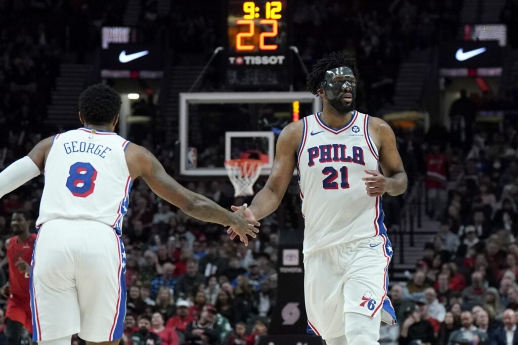 Philadelphia 76ers center Joel Embiid (21) and forward Paul George