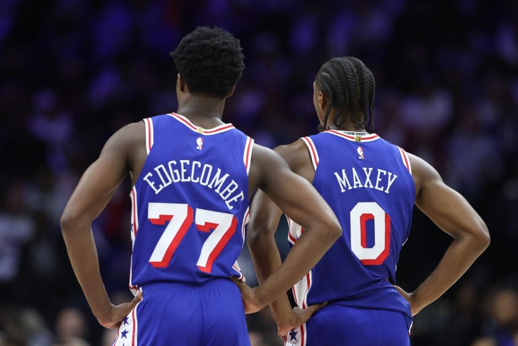 Philadelphia 76ers guard VJ Edgecombe (77) and guard Tyrese Maxey (0) look on during the third quarter against the Charlotte Hornets at Xfinity Mobile Arena.